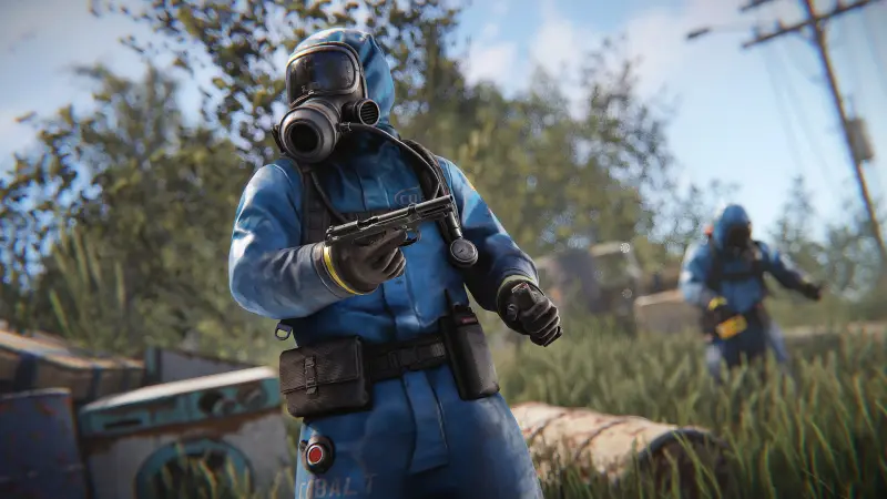 A Rust survivor in a blue hazmat suit holding a submachine gun